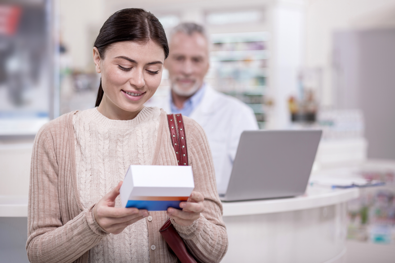 woman looking at prescription box